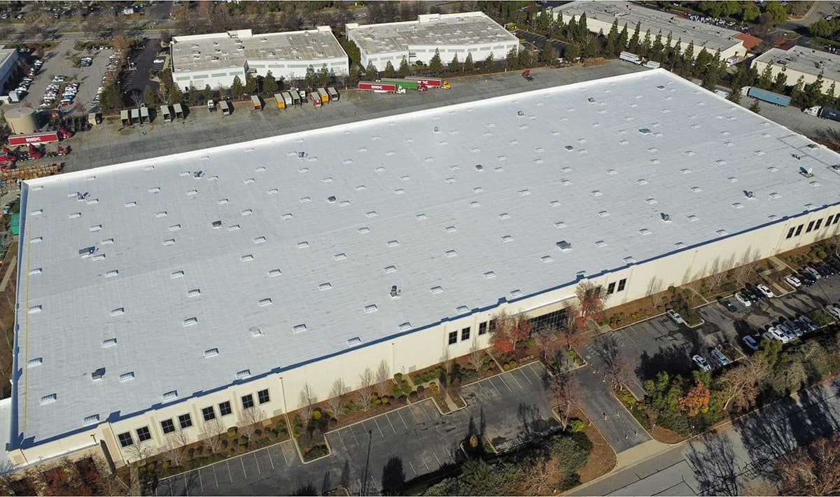 Aerial drone photo of a finished commercial roof coating project