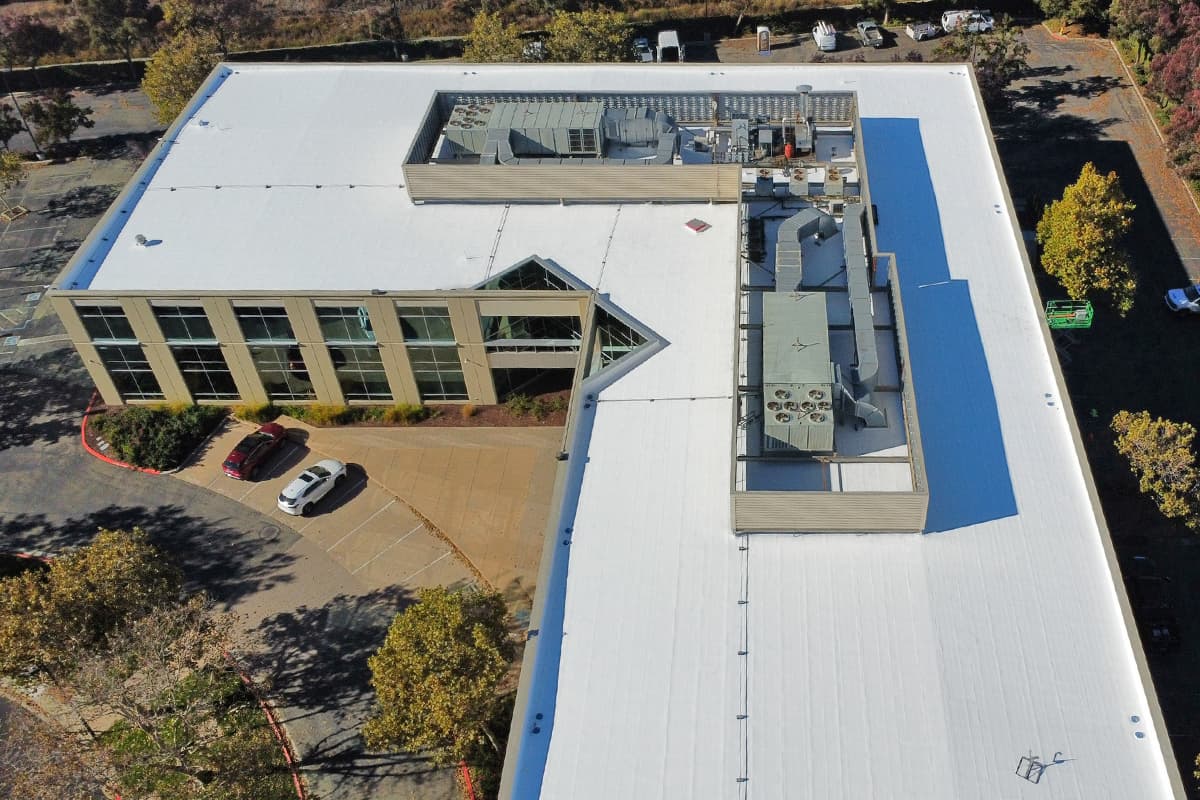 Aerial view of a commercial office building roof coating project